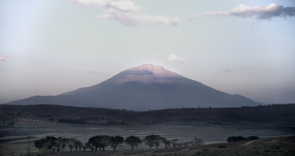 Mount Meru rising above the Arusha plains, home to Mondul Coffee Estates since 1931